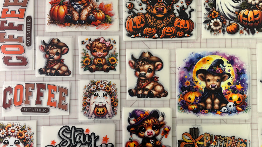 Printed Halloween DTF transfers laid out on a cutting mat